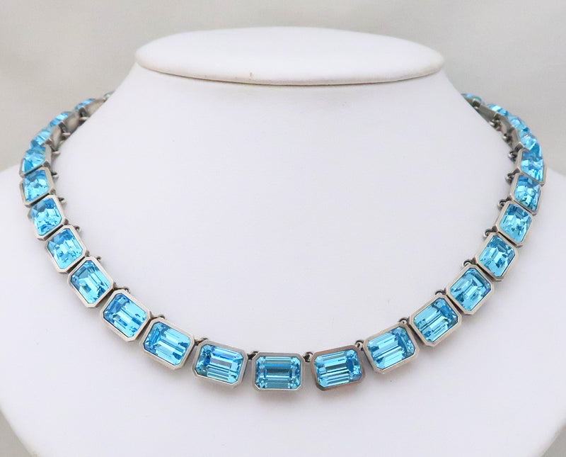 A light turquoise long emerald-cut paste rivierein sterling ...