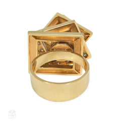 A gold and diamond kinetic "spinner" ring comprised of verti...