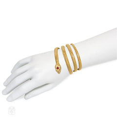 Antique woven gold coiled snake bracelet with gemset head