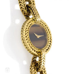 Gold wristwatch with tiger's eye face, L'Enfant for Hermès